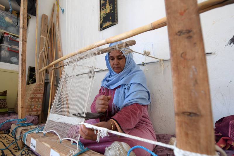 A craftswoman weaves a rug in the Tunisian oasis of Nefta, at a workshop run by Shanti, a social enterprise that helps artisans in the North African country. All photos: AFP