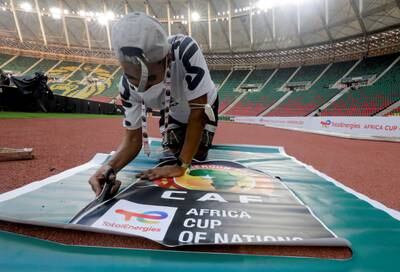 A worker prepares banners at the Olembe Stadium, which is hosting the opening ceremony of the Africa Cup of Nations. Reuters