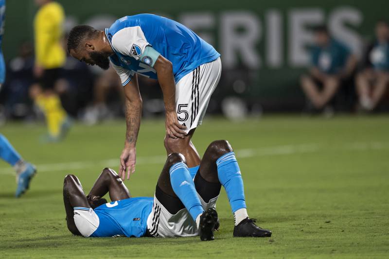 Charlotte defender Anton Walkes checks on midfielder Derrick Jones after a collision. AP