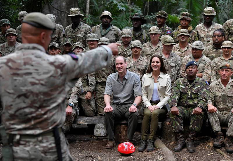 The Duke and Duchess of Cambridge sit for a photo with military personnel from Britain and Belize. Getty Images