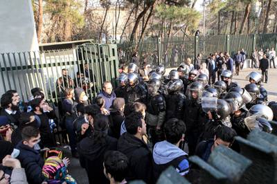 This photo shows anti-riot police preventing university students from joining other protesters in Tehran, Iran on December 30. AP