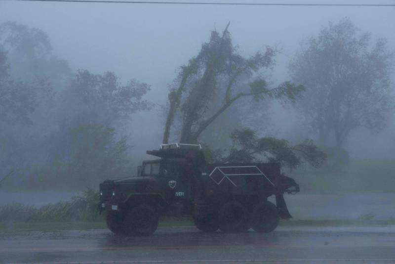 A truck is seen in heavy winds and rain from Hurricane Ida in Bourg. AFP