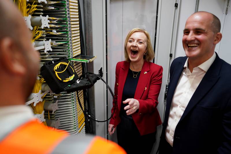 Ms Truss and Jake Berry, Member of Parliament for Rossendale and Darwen, during a visit to a broadband interchange company in Leeds. PA