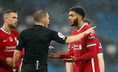 Liverpool's Joe Gomez appeals to referee Craig Pawson after his handball results in a penalty for City. PA