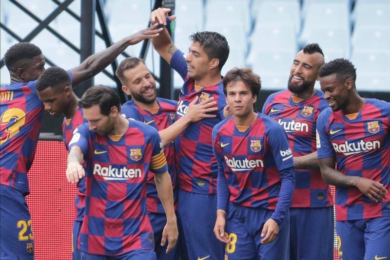 Barcelona's Luis Suarez, centre, celebrates after scoring the opening goal. AP