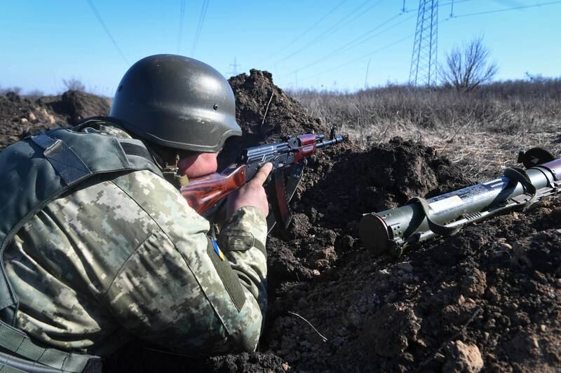 Ukrainian soldiers patrol the road near Kharkiv, Ukraine, as the Russian invasion continues. EPA