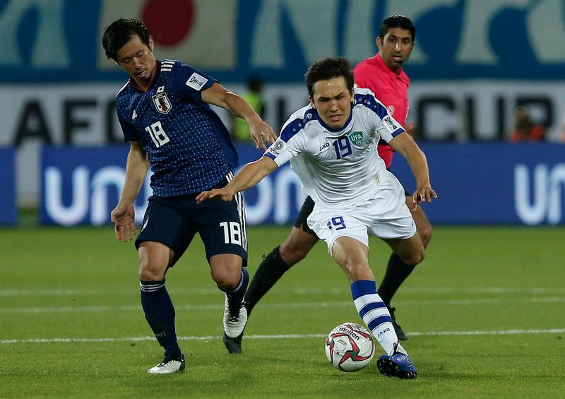 Uzbekistan's Otabek Shukurov, right, fights for the ball against Japan's Hidemasa Morita. AP Photo