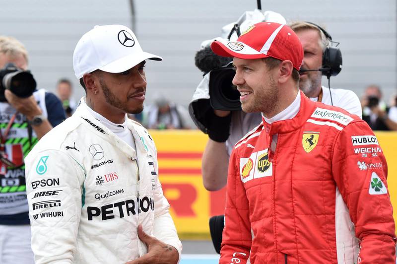 Pole position winner Mercedes' British driver Lewis Hamilton (L) speaks with third placed Ferrari's German driver Sebastian Vettel after the qualifying session at the Circuit Paul Ricard in Le Castellet, southern France, on June 23, 2018, ahead of the Formula One Grand Prix de France. / AFP / Boris HORVAT                        
