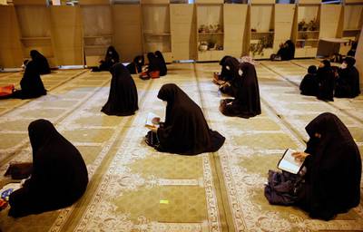 Iranian women wearing face masks pray during a religious ceremony called Laylat Al Qadr in a mosque at the Tehran's university, in Tehran.  EPA