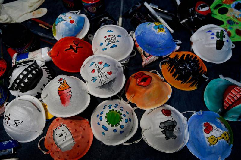 Dust masks painted by Palestinian artists Samah Saed and Dorgam Krakeh for a project raising awareness about the COVID-19 coronavirus pandemic in Gaza City.   AFP