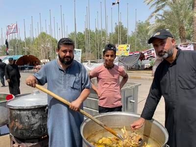 Ali Al Safi (left), 35, travelled from the southern province of Thi Qar to serve the protesters with food.  All photos: Sinan Mahmoud/The National