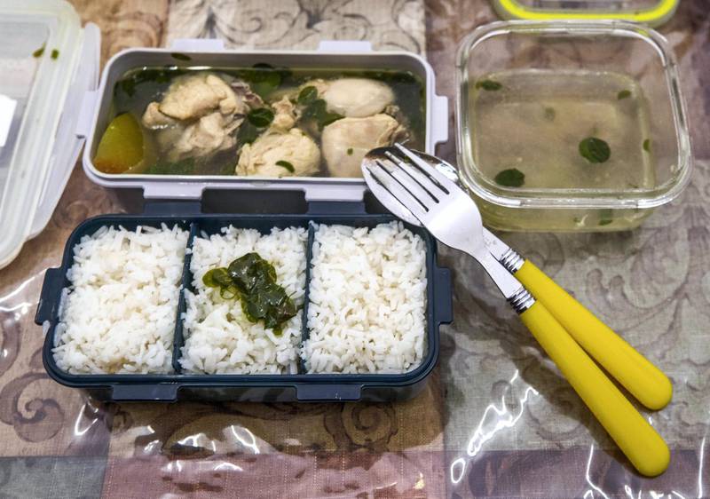 Abu Dhabi, U.A.E., August 28,, 2018. 
 British Veterinary Centre's Filipino staff were ordering their lunch each day from the same restaurant, the Khalidyah branch of Royal Pinoy but they got fed up of all the plastic waste.  So the admin manager, Jennifer Hale, ordered reusable lunch kits which the restaurant now refills each day for them.  Chicken with green papaya and ginger broth with rice, a Filipino favorite known as Tinolang Manok.
Victor Besa/The National
Section:  NA