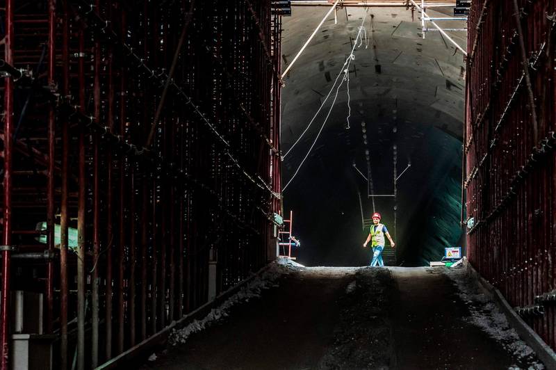 A construction worker walks through the entrance of the new twin-tube tunnel. AFP