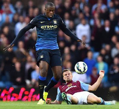 Manchester City's Yaya Toure, left, vies with Aston Villa's Andreas Weimann for the ball during City's Premier League victory on Saturday in Birmingham. Ben Stansall / AFP / October 4, 2014 
