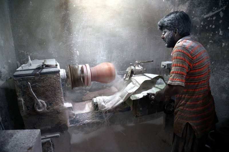 A labourer works at a factory that produces handicrafts made of salt in Karachi, Pakistan. EPA