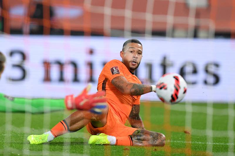 Netherlands forward Memphis Depay slides to slot home the Netherlands' second. AFP