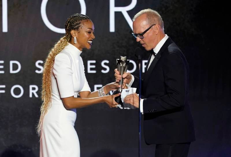 Sonequa Martin-Green, left, presents the award for Best Actor in Limited Series to Michael Keaton for 'Dopesick'. AP