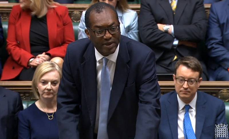 Britain's former chancellor of the exchequer, Kwasi Kwarteng, unveils the mini-budget in the House of Commons in London on September 23, 2022, as Liz Truss watches on.  AFP
