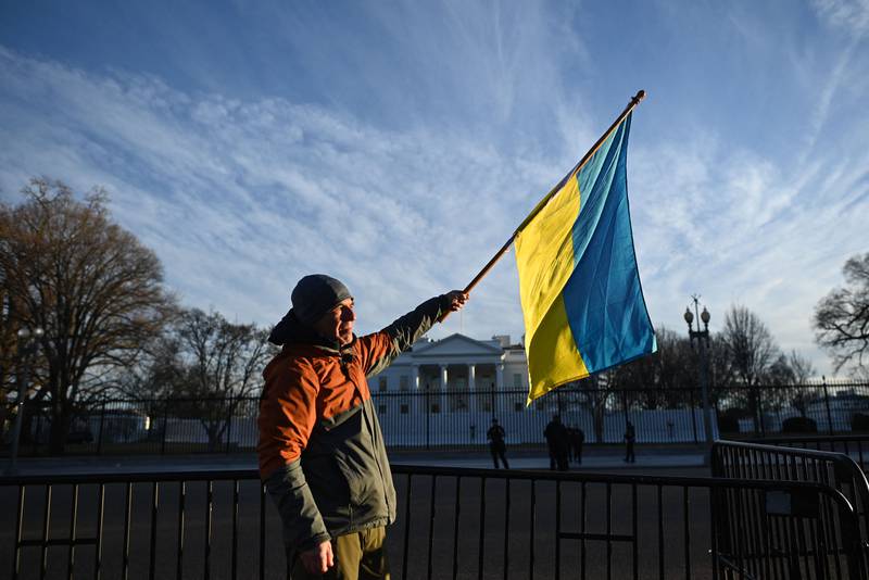 An activist holds a Ukrainian flag during a protest at Lafayette Square, across from the White House in Washington on Friday. AFP