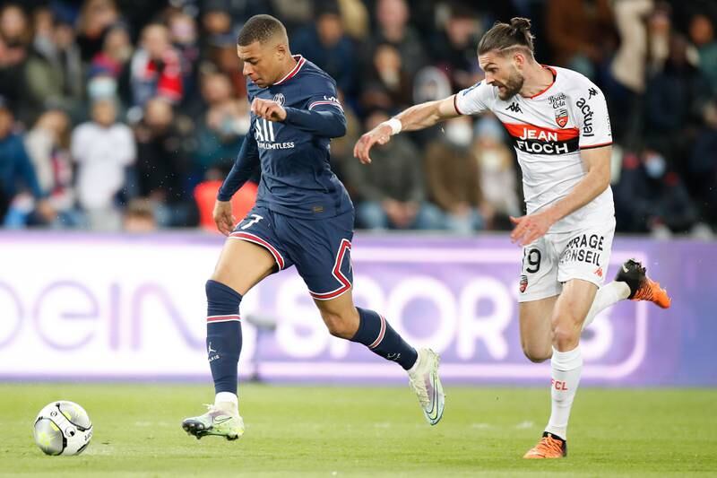 Kylian Mbappe takes the ball past Lorient's Leo Petrot during the Ligue 1 match at Parc des Princes. EPA
