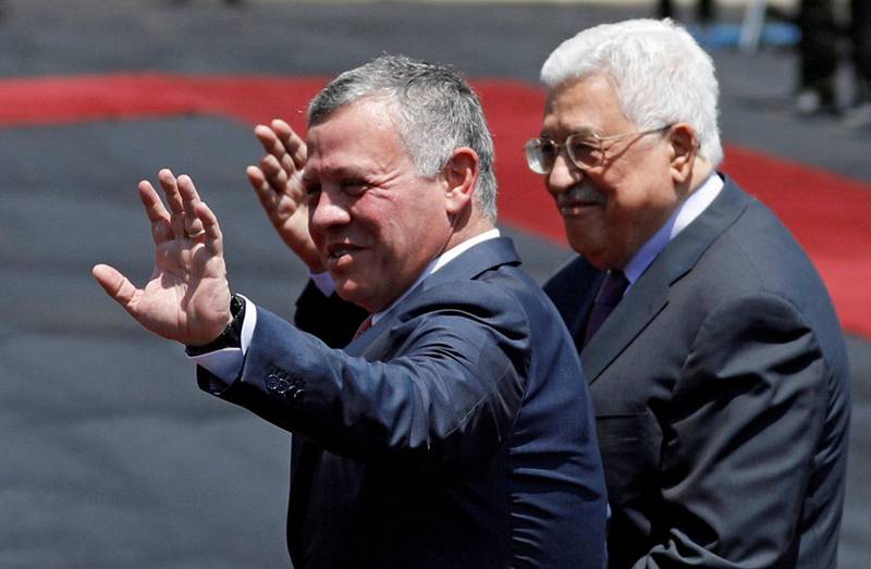 Jordan's King Abdullah II and Palestinian President Mahmoud Abbas wave during a reception ceremony in the West Bank city of Ramallah, August 7, 2017. REUTERS/Mohamad Torokman