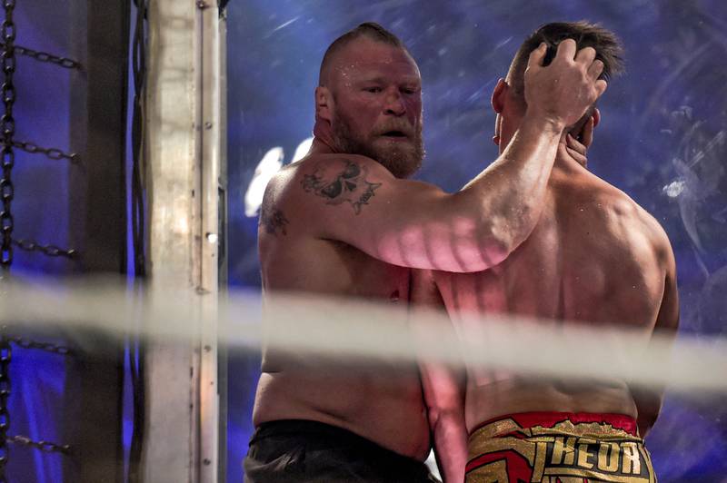 Brock Lesnar, left, wrestles with Austin Theory.