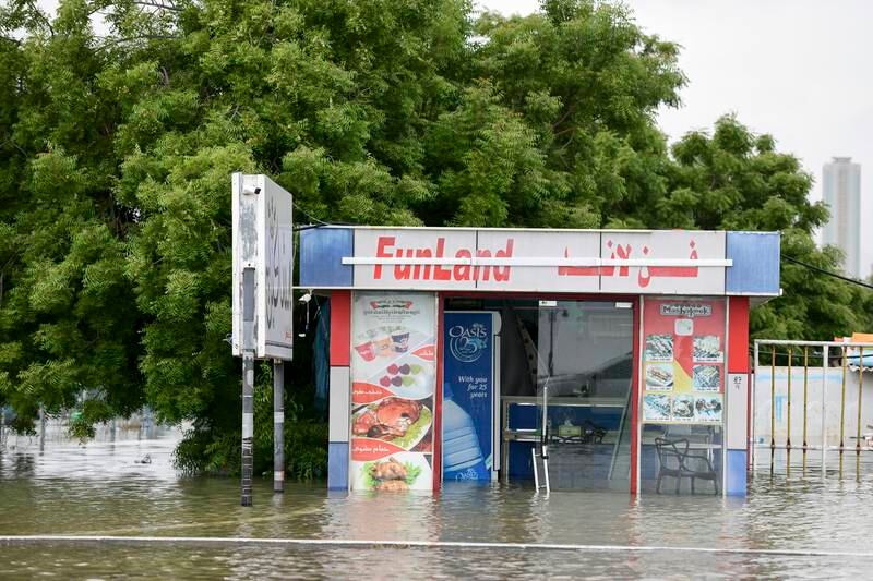 A flooded shop on the corniche in Fujairah. Khushnum Bhandari / The National
