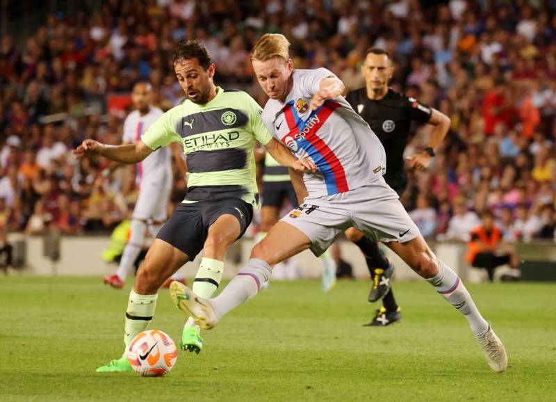Barcelona's Frenkie de Jong in action with Manchester City's Bernardo Silva. Reuters