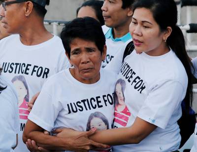 Family members wait for the arrival of the body of Joanna Demafelis, a Filipina domestic helper who was killed and found inside a freezer in Kuwait, in her hometown in Iloilo province in the Philippines February 17, 2018.  REUTERS/Erik De Castro