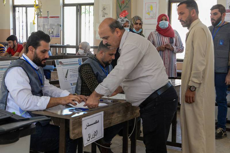 A man registers to vote at a polling station in the northern city of Mosul. Photo: AFP