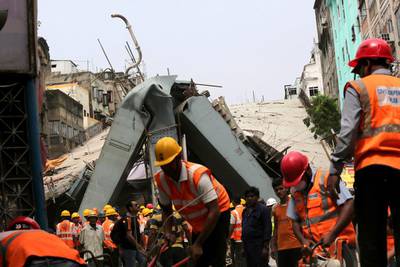 National Disaster Response Force and Indian army personnel work to recover victims after a bridge under construction collapsed in Kolkata, India. At least 24 people have died in a under construction flyover that collapsed and several others are feared trapped in the rubble, police said. Piyal Adhikary / EPA