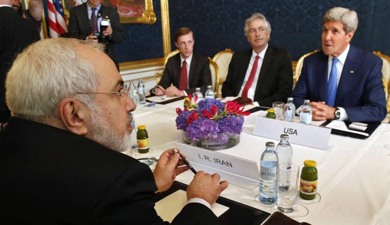 Iran's foreign minister Javad Zarif, left, holds a meeting with US secretary of state John Kerry, right, in Vienna last year. In the forthcoming Camp David summit, the Americans are likely to point out that such negotiations are the only viable means short of a conflict to prevent Iran from gaining nuclear weapons. Jim Bourg / Reuters