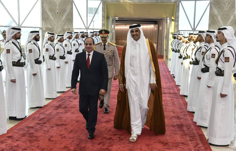 In this photo provided by Egypt's presidency media office, Qatari Emir Tamim bin Hamad Al Thani, right, accompanies Egyptian President Abdel-Fattah el-Sissi, on his arrival in Doha, Qatar, Tuesday, Sept. 13, 2022.  Egypt’s president travelled on Tuesday to Qatar on his first visit to the gas-rich nation amid warming ties after years of frayed relations following the Egyptian military’s overthrow of an Islamist president backed by Doha. (Egyptian Presidency Media Office via AP)