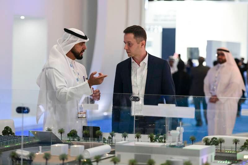 Visitors at the Dubai Electricity and Water Authority stand at Abu Dhabi Sustainability Week in Adnec, Abu Dhabi. Khushnum Bhandari / The National