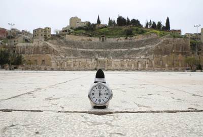 A watch showing the time at noon, is displayed for a photo in front of the Roman amphitheatre, which is empty during the coronavirus disease outbreak, in Amman, Jordan. Reuters
