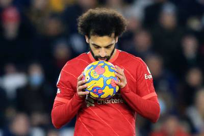 Liverpool's Egyptian midfielder Mohamed Salah kisses the ball before taking a penalty, that was saved by Leicester City's Danish goalkeeper Kasper Schmeichel (unseen) during the English Premier League football match between Leicester City and Liverpool at King Power Stadium in Leicester, central England on December 28, 2021.  (Photo by Lindsey Parnaby / AFP) / RESTRICTED TO EDITORIAL USE.  No use with unauthorized audio, video, data, fixture lists, club/league logos or 'live' services.  Online in-match use limited to 120 images.  An additional 40 images may be used in extra time.  No video emulation.  Social media in-match use limited to 120 images.  An additional 40 images may be used in extra time.  No use in betting publications, games or single club/league/player publications.   /  