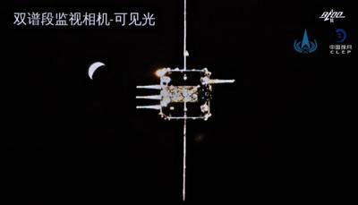 The orbiter-returner combination of China's Chang'e-5 probe approaching the ascender.  China National Space Administration / EPA