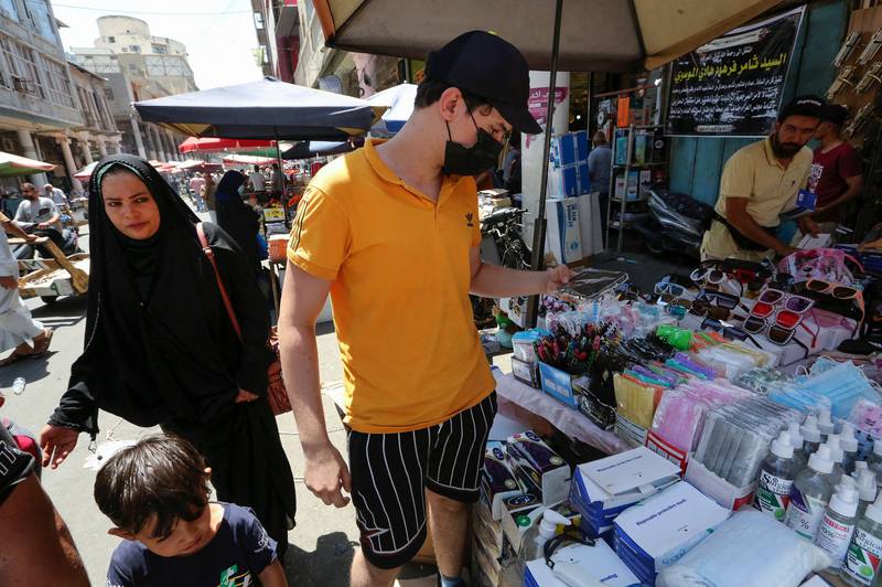 Iraqis browse protective items such as hand sanitisers and masks at a stall in a market street in the capital Baghdad on July 12. AFP