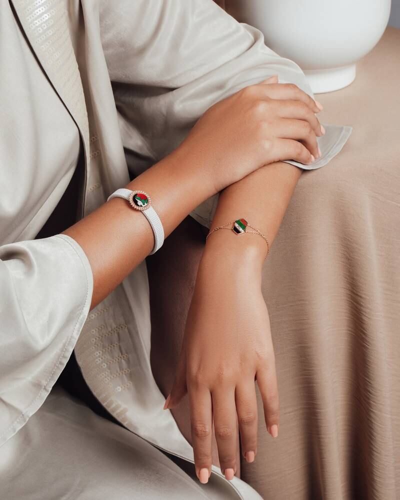 The La Marquise Sands of Time bracelet and a delicate gold bracelet with the flag redrawn in fluid lines. The reverse  of both is marked with the Expo 2020 Dubai logo. Photo: La Marquise