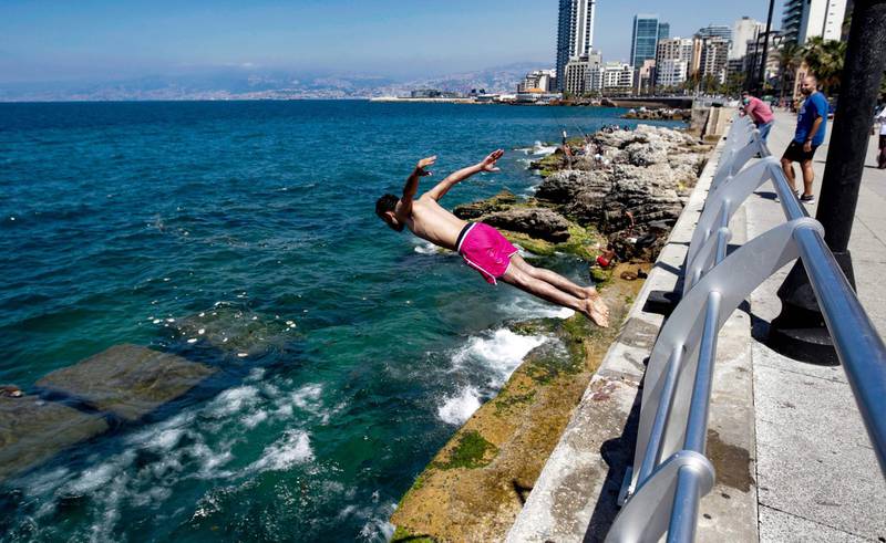 A young boy dives into the sea in Beirut.  AFP