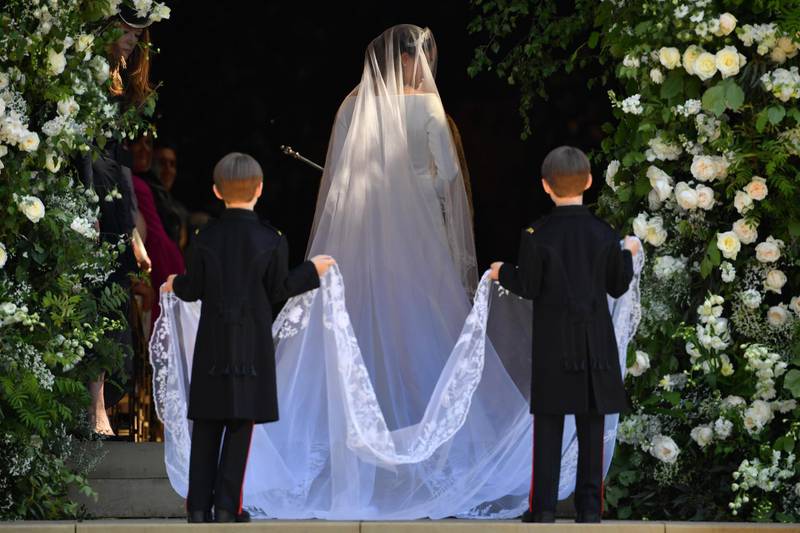 The twins were tasked with getting Meghan's train - which was embroidered with flowers from across the Commonwealth - ready to go down the aisle. Getty