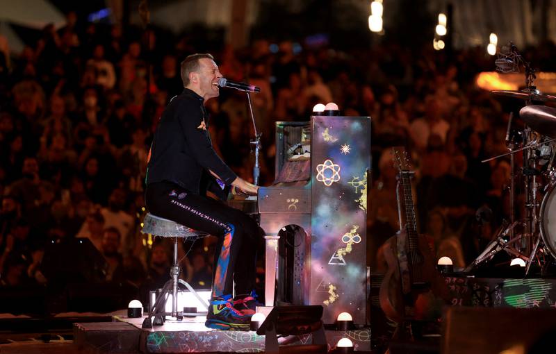 Chris Martin takes a seat at the piano to croon along to a song.