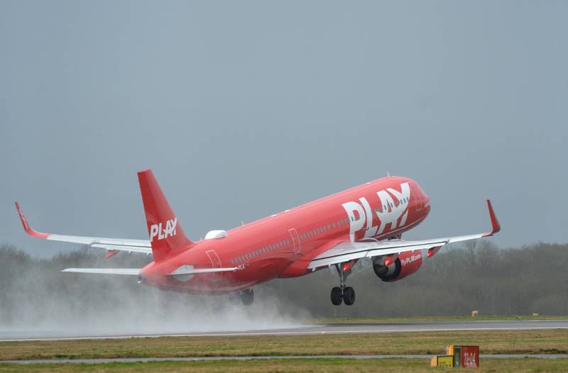 A plane takes off from a wet Stansted Airport in Essex. PA