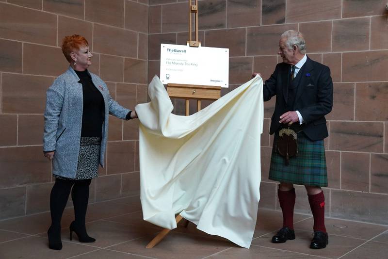 King Charles III unveils a plaque which reads: 'The Burrell Collection opened 13 October 2022 by His Majesty the King.' AFP