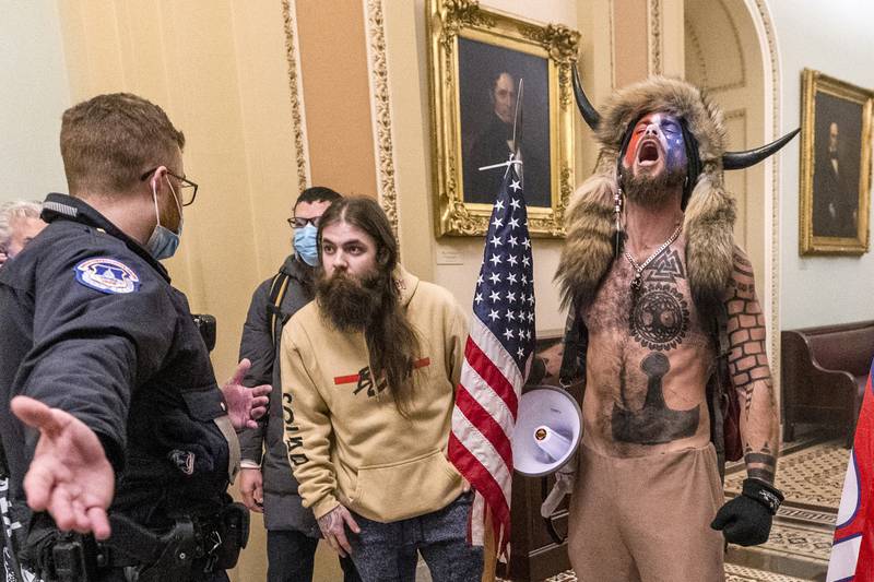 Supporters of Donald Trump, including Jacob Chansley, right with fur hat, are confronted by US Capitol Police officers outside the Senate Chamber inside the Capitol in Washington on January 6, 2021. More than 800 people across the US have been charged in the Jan 6 riot. AP