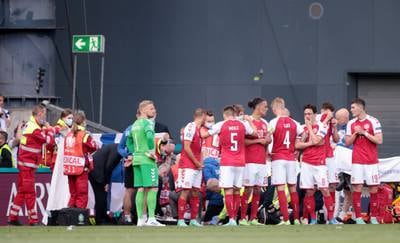 Denmark players surround Christian Eriksen as he receives medical attention. Reuters