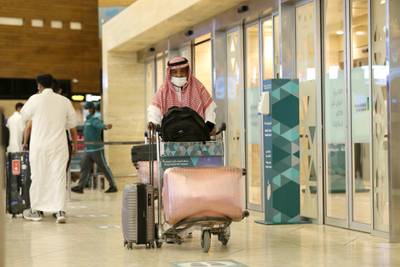A traveller pushes his luggage at the King Khalid International Airport as Saudis were allowed to travel abroad once again. Reuters