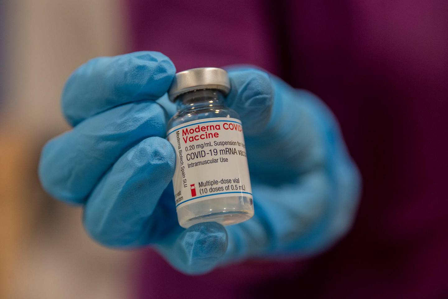 A health worker holds a vial of the Moderna vaccine, during a COVID-19 vaccination campaign at the Nurse Isabel Zendal Hospital in Madrid, Spain, Wednesday, March 17, 2021. (AP Photo/Manu Fernandez)