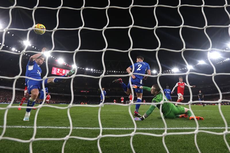 Martin Odegaard of Arsenal scores the team's third goal past Vitaliy Mykolenko, James Tarkowski and Jordan Pickford of Everton. Getty Images