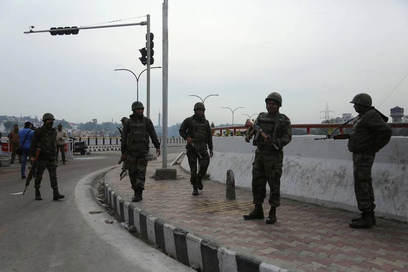 Indian army soldiers patrol during the third day of curfew in Jammu, India, Sunday, Feb. 17, 2019. The Indian army staged flag marches in sensitive localities, a day after violence was reported during protests against the Pulwama terror attack in which at least 40 soldiers were killed, officials said. (AP Photo/Channi Anand)